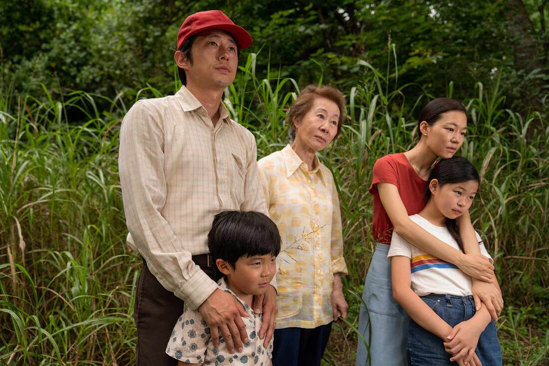 Minari film publicity still of the Yi family standing in tall grass, courtesy of A24